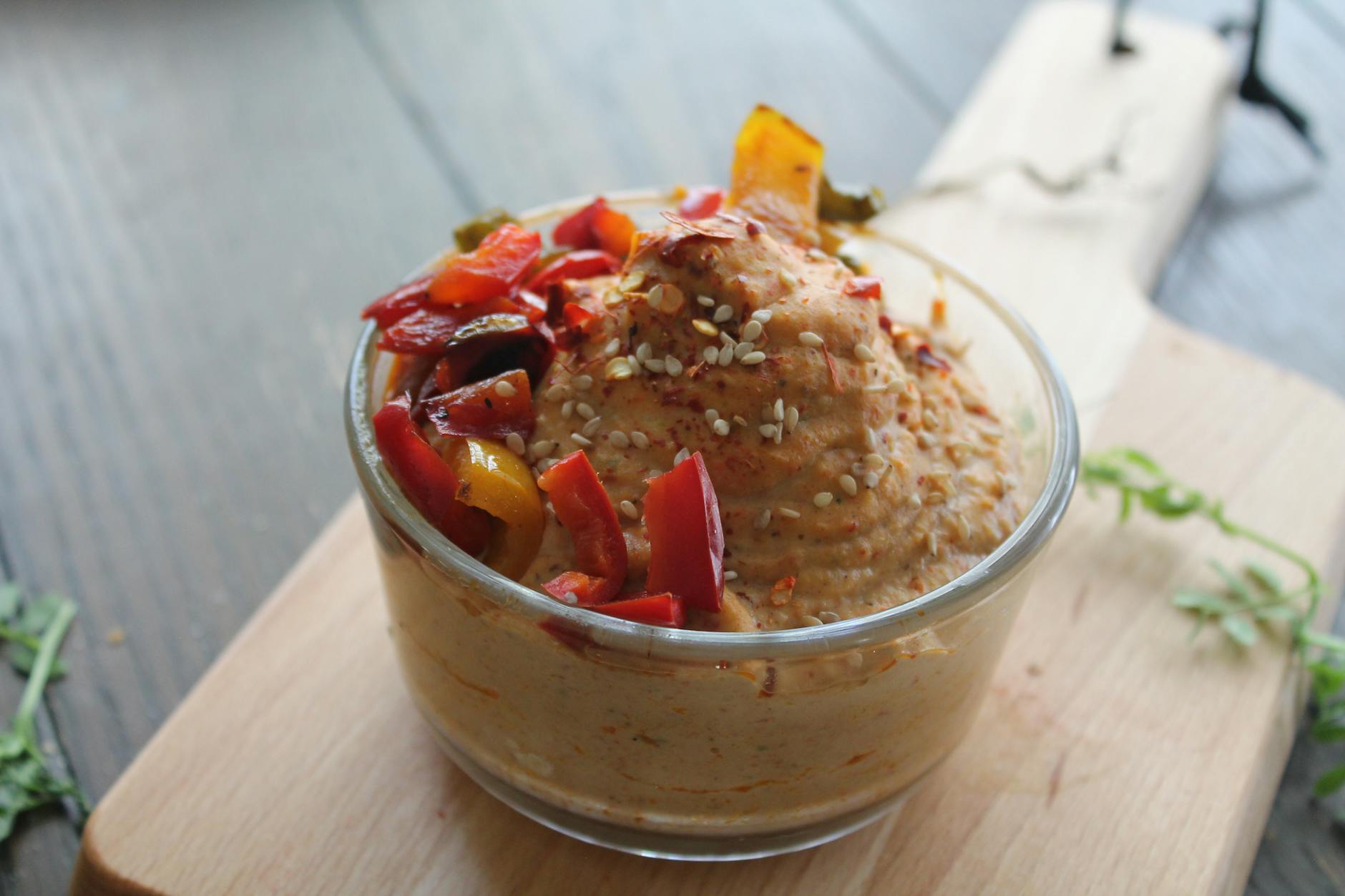 hummus in bowl on cutting board