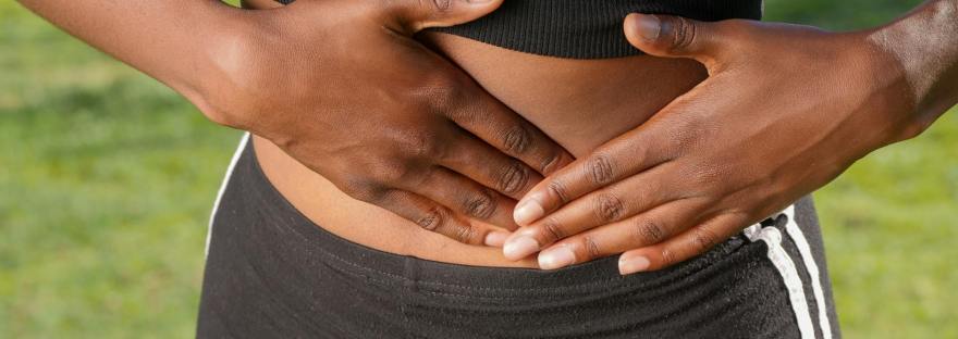 close up photo of woman touching her abdomen