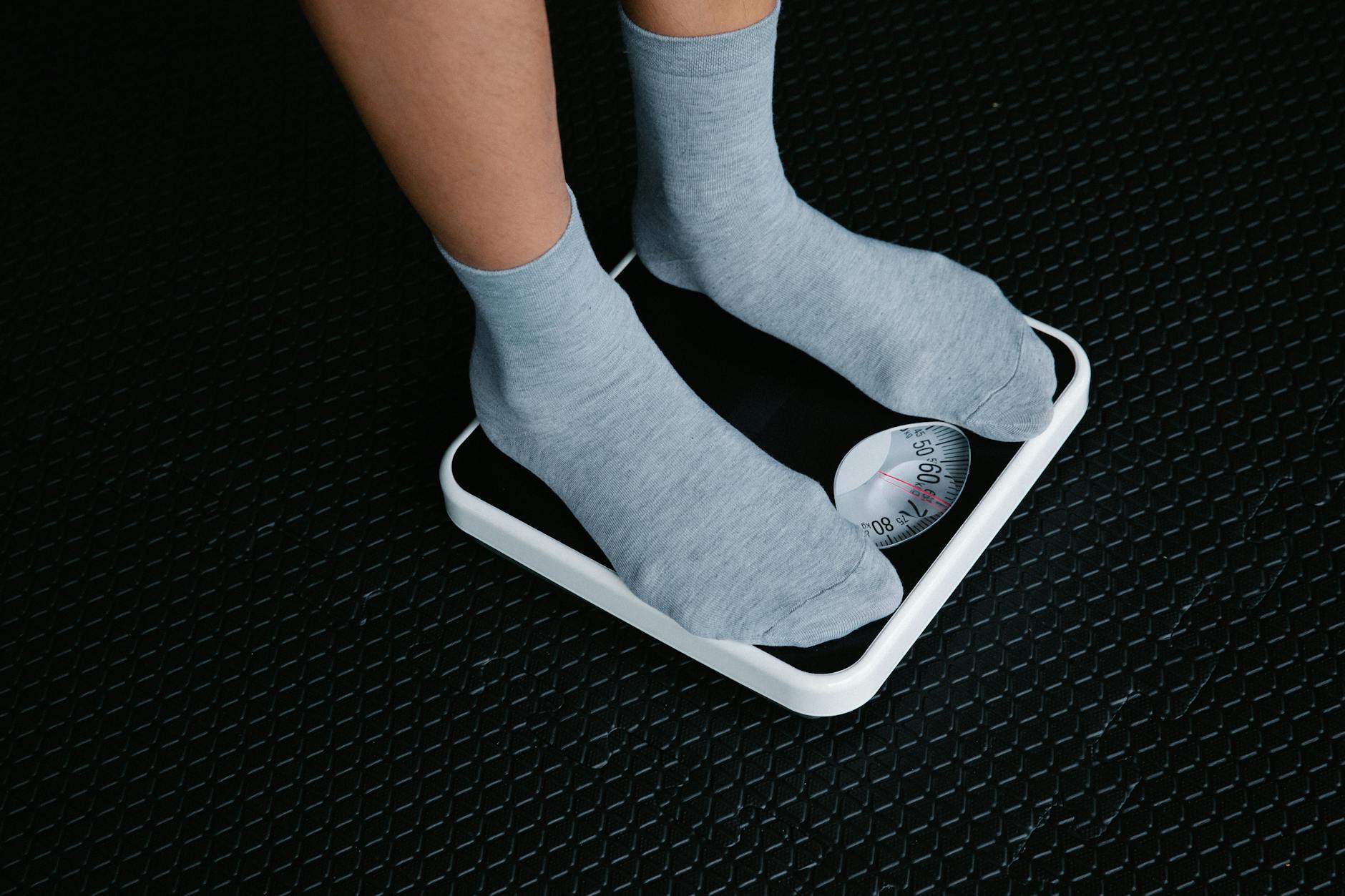 legs in socks standing on scale