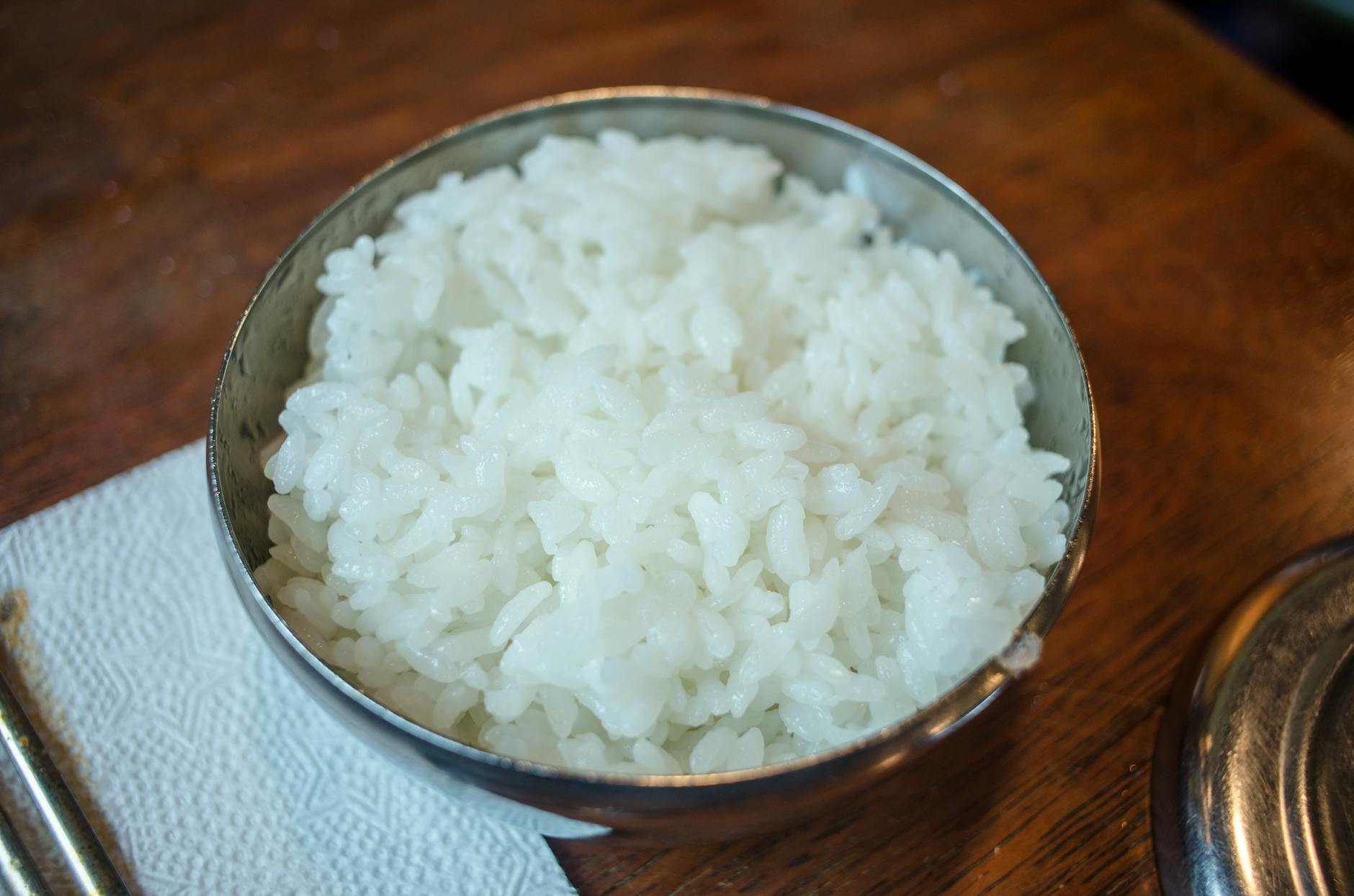 a white rice on a stainless bowl